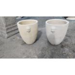 Pair of moulded stone planters decorated with lions masks {55 cm H x 45 cm Dia}.