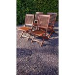 Four teak garden chairs {92 cm H x 50 cm W x 60 cm D}.