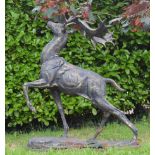 Cast iron model of standing Deer with raised head and hoof on oval plinth {155 cm H x 130 cm W x