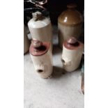 Three stoneware hot water bottles and stoneware flagon. {33 cm H x 14 cm W x 15 cm D}, {27 cm H x 12