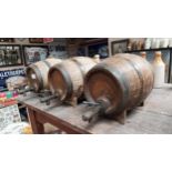 Set of three ceramic kegs with original wooden taps. {20 cm H x 26 cm W x 16 cm D}.