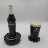 Two Guinness Perspex counter fonts in the form of a Guinness Bottle { 28cm H X 15cm Dia } and