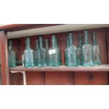 Thirteen shear top rectangular Kandee Sauce Dublin bottles and one round Kandee Sauce bottle. {{15