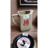 J and B Scotch Whiskey ceramic water jug. {16 cm H x 16 cm W x 9 cm D}.