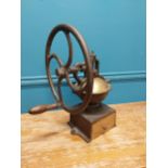 Early 20th C. cast iron and brass wheel coffee grinder {50 cm H x 40 cm W x 34 cm D}.