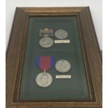 Set of replica Waterloo & Queen's South Africa medals with ribbons mounted in a glazed case.