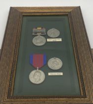 Set of replica Waterloo & Queen's South Africa medals with ribbons mounted in a glazed case.