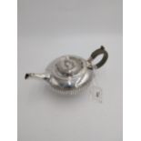 Irish Georgian silver teapot, the squat circular body with fluted central band, wooden handle with