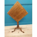 19th C. mahogany tilt top wine table raised on turned column and three outswept feet {69 cm H x 45