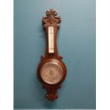 Edwardian carved oak barometer with silvered dial {75 cm H x 24 cm W}.