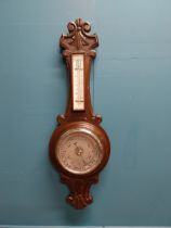 Edwardian carved oak barometer with silvered dial {75 cm H x 24 cm W}.