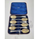 Set of six Georgian gilded silver berry serving spoons, the scalloped bowls with embossed exotic