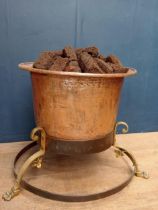 Copper and brass log bucket raised on wrought iron base with lions paw feet {H 68cm x Dia 100cm }.