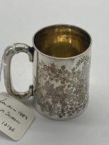 English silver mug decorated with foliage. Hallmarked in London 1884. Maker George Maudsley Jackson.