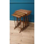 Victorian walnut and satinwood inlaid nest of four tables raised on turned columns and platform feet