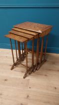 Victorian walnut and satinwood inlaid nest of four tables raised on turned columns and platform feet