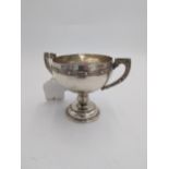 Irish silver trophy cup, the round body with two handles decorated with Celtic design inscribed