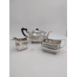 Irish Georgian silver teapot, sugar bowl and cream jug, of oval bellied form, decorated with