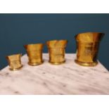 Set of four brass graduated measures {Largest 12 cm H x 14 cm W x 10 cm D and Smallest 5 cm H x 7 cm