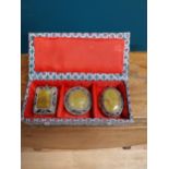 Boxed set of three decorative lockets.