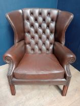Brown leather deep button wingback chair raised on square legs {H 95cm x W 85cm x D 65cm }.