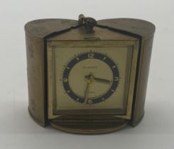 Europa travel clock in brass case. { 7cm H X 6cm W X 4cm D }.
