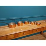 Set of five good quality 20th C. French graduated copper saucepans with wrought iron handles {18