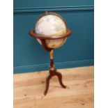 Good quality mahogany and gilded brass world globe raised on turned column and three outswept