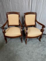 Pair of Regency carved mahogany and upholstered arm chairs.