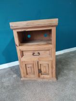 Stripped pine side cabinet with single drawer in frieze over blind door. {92 cm H x 59 cm W x 41