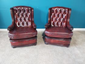 Pair of deep buttoned leather and mahogany wingback armchairs {93 cm H 68 cm W 74cm D}.