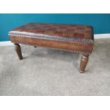 Leather upholstered footstool on turned stained pine legs. {47 cm H x 102 cm W x 52 cm D}.{ cm H