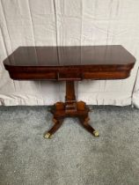 Regency rosewood turn over leaf card table raised on single column, platform base and three four