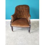 Victorian mahogany and upholstered arm chair raised on turned legs and brass castors.