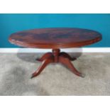 Mahogany oval coffee table on turned column with four outswept feet. {53 cm H x 110 cm W x 66 cm