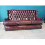 Deep buttoned leather and mahogany three seater sofa {95 cm H 178 cm W 74cm D}.