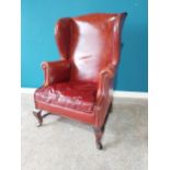 Leather wingback armchair raised on mahogany cabriole legs {114 cm H 77 cm W 67cm D}.