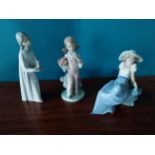 Three Lladro ceramic figurines {20 cm H, 18 cm H and 14 cm H}.{ cm H cm W cm D}.