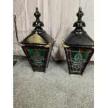 Pair of metal and painted brass wall lanterns with leaded stain glass panels and brackets.