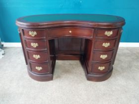 Mahogany kidney shaped desk with inset leather top with single long drawer flanked by eight short