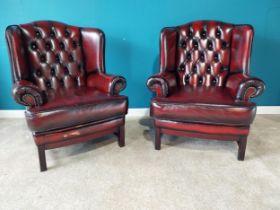 Pair of deep buttoned leather wingback armchairs raised on square mahogany legs {102 cm H 82 cm W