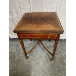 Mahogany envelope card table with single drawer raised on square tapered legs and brass castors {