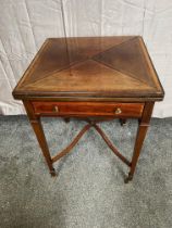 Mahogany envelope card table with single drawer raised on square tapered legs and brass castors {