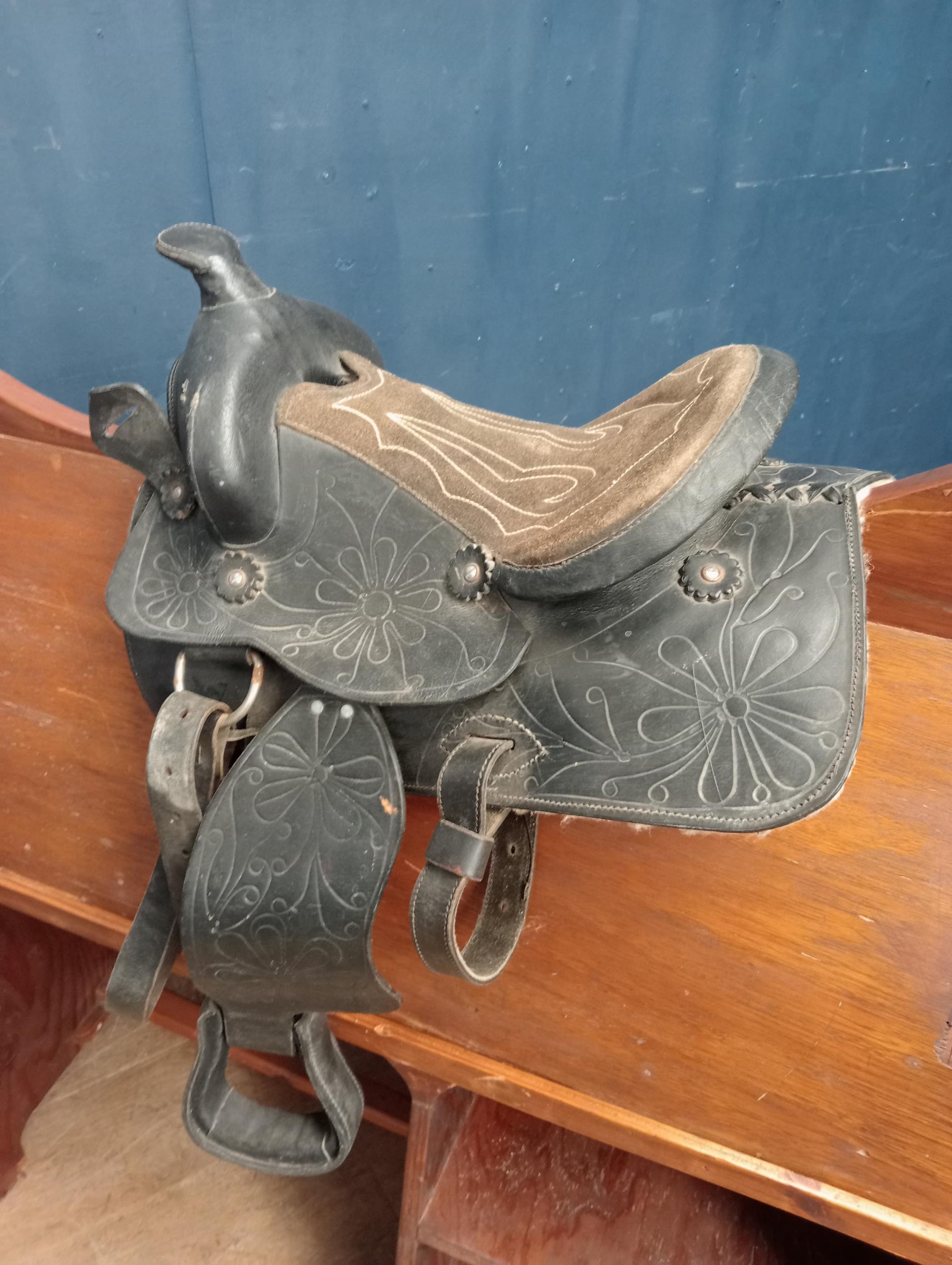 Cowboys leather saddle {H 60cm x W 50cm x D 40cm }.