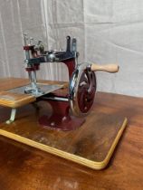 Small cased sewing machine in working order.