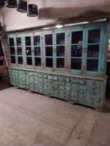 Good quality painted hardwood shop cabinet with eight glazed doors above forty five bank of