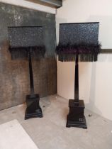 Pair of Italian designer Altamoda ebonised standard lamps with decorative glitter lamps {193 cm H