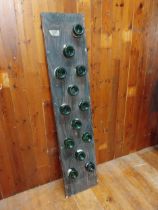 Champagne bottles mounted on oak plaque {160 cm H x 35 cm W x 10 cm D}.