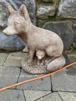 Stone model of fox with cubs. {41 cm H}.