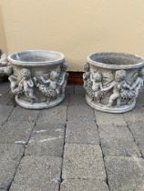 Pair of circular stone planters decorated with cherubs. {32 cm H x 36 cm Dia.}.